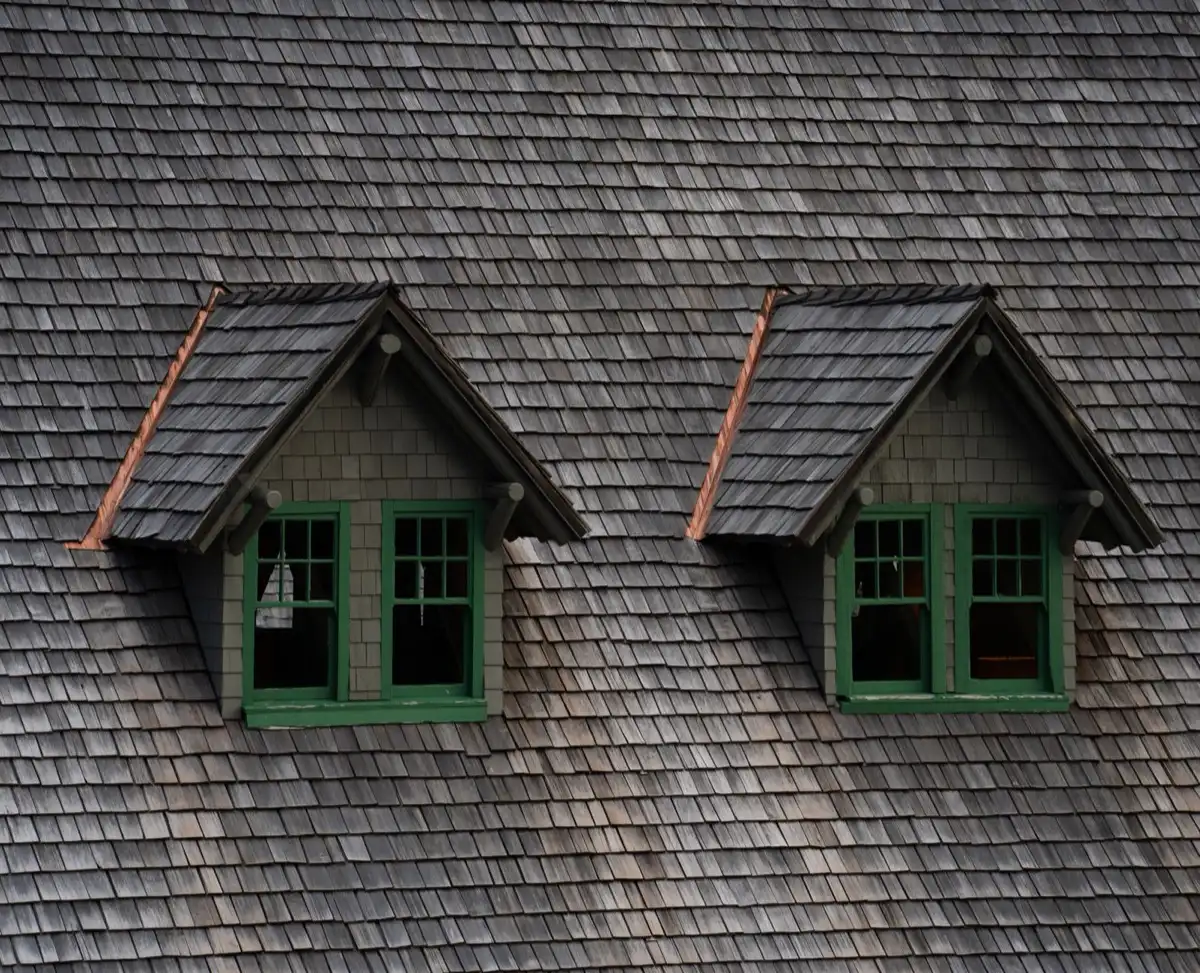 Dormers on a shingle roof in Carrollton, TX, where step flashing and kickout flashing carry water past the walls