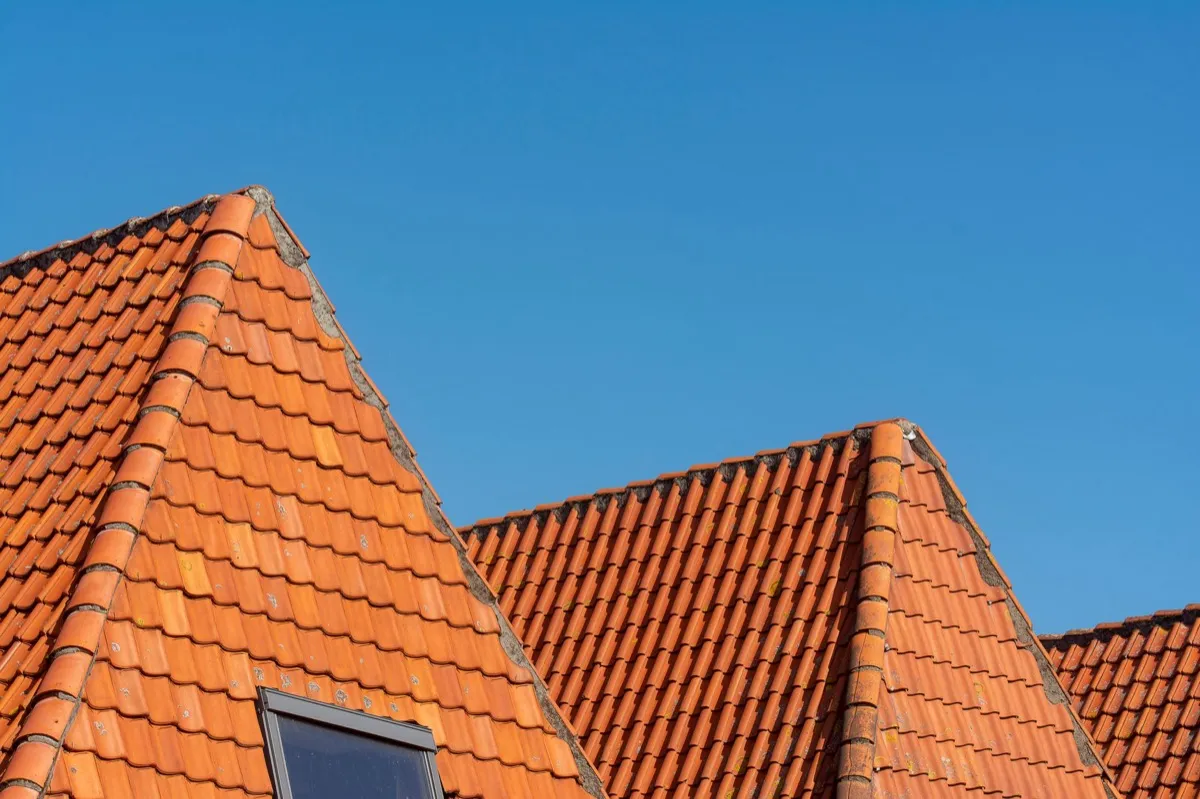 Clay barrel tile rooflines on homes in Carrollton, TX